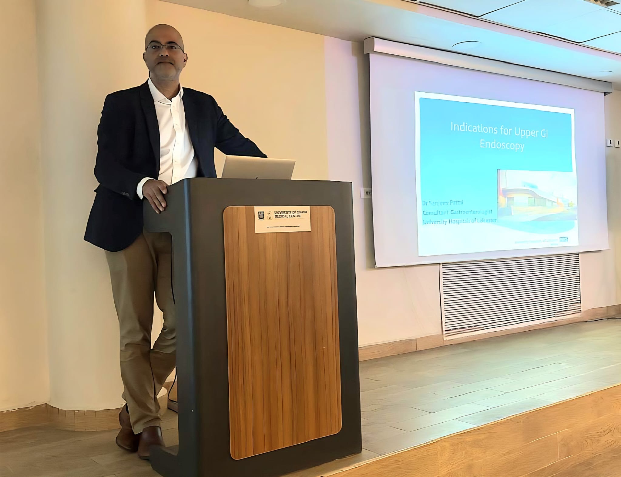 Dr. Pattni speaking at a medical conference